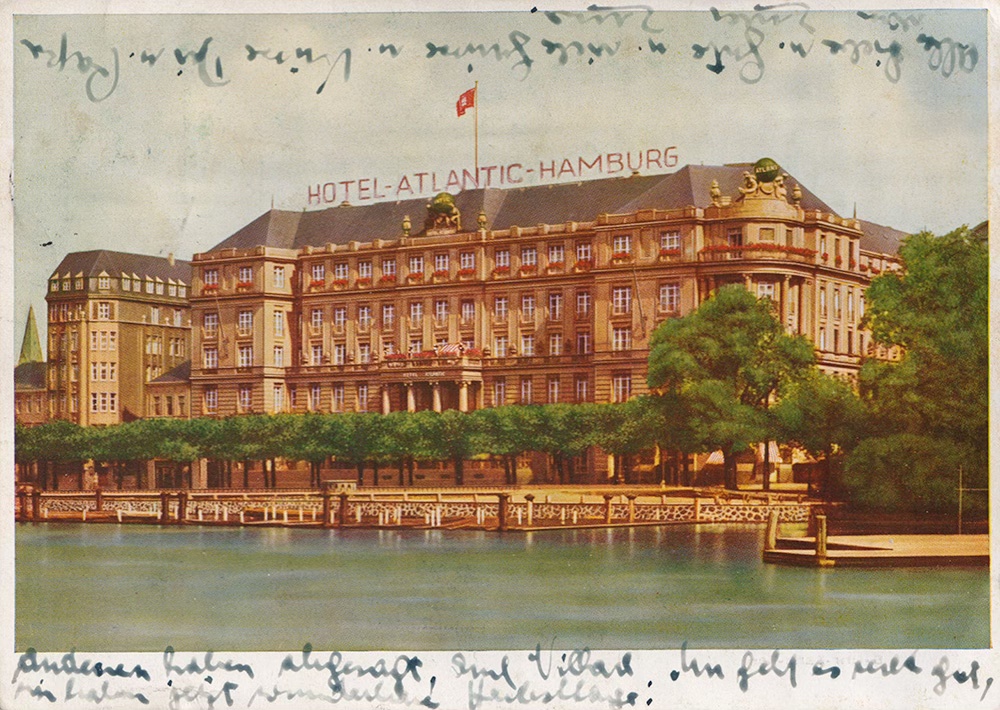 Colour postcard showing the exterior of the Hotel-Atlantic on the lake in Hamburg