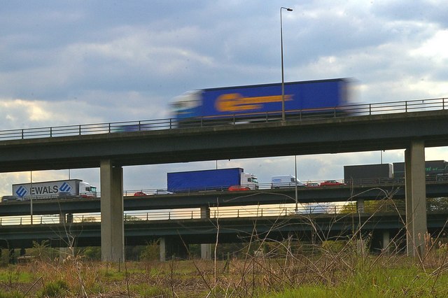 Photograph of lorries passing over road bridges above the Mardyke river valley